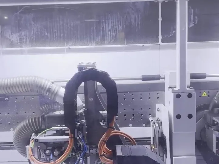 Machining head inside a CNC centre boring system holes and hardware bores behind the guard