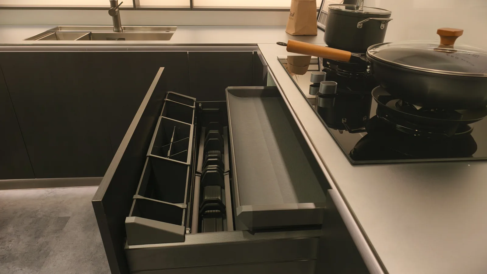 Kitchen drawer with cutlery dividers, spice drawers and a knife block, drawer runners visible