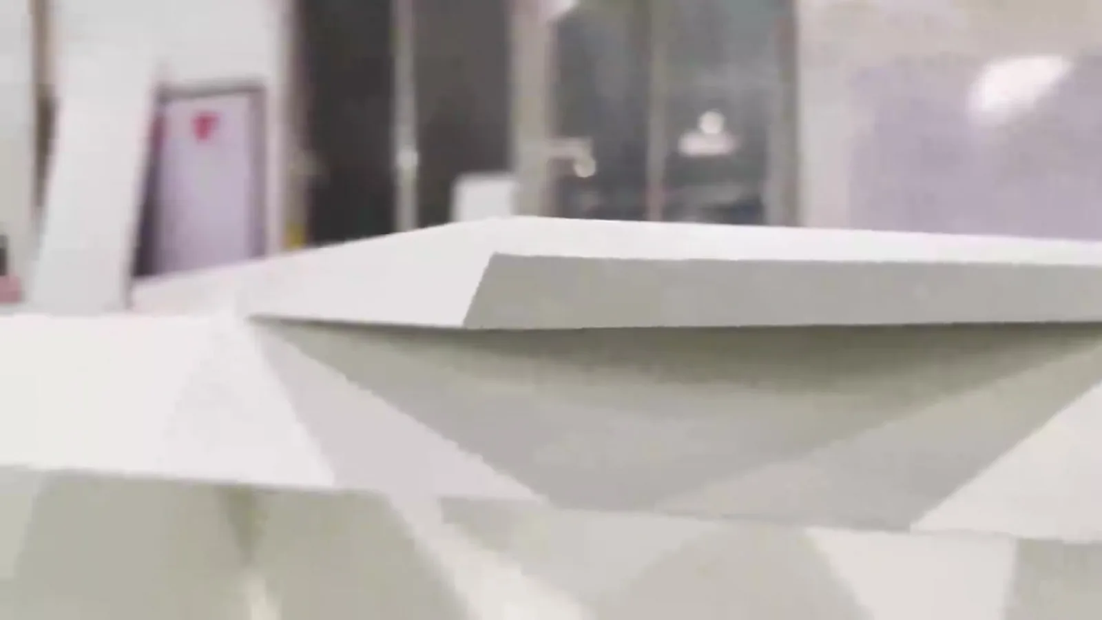 Close-up of a cut cabinet panel edge showing the banding and the board beneath