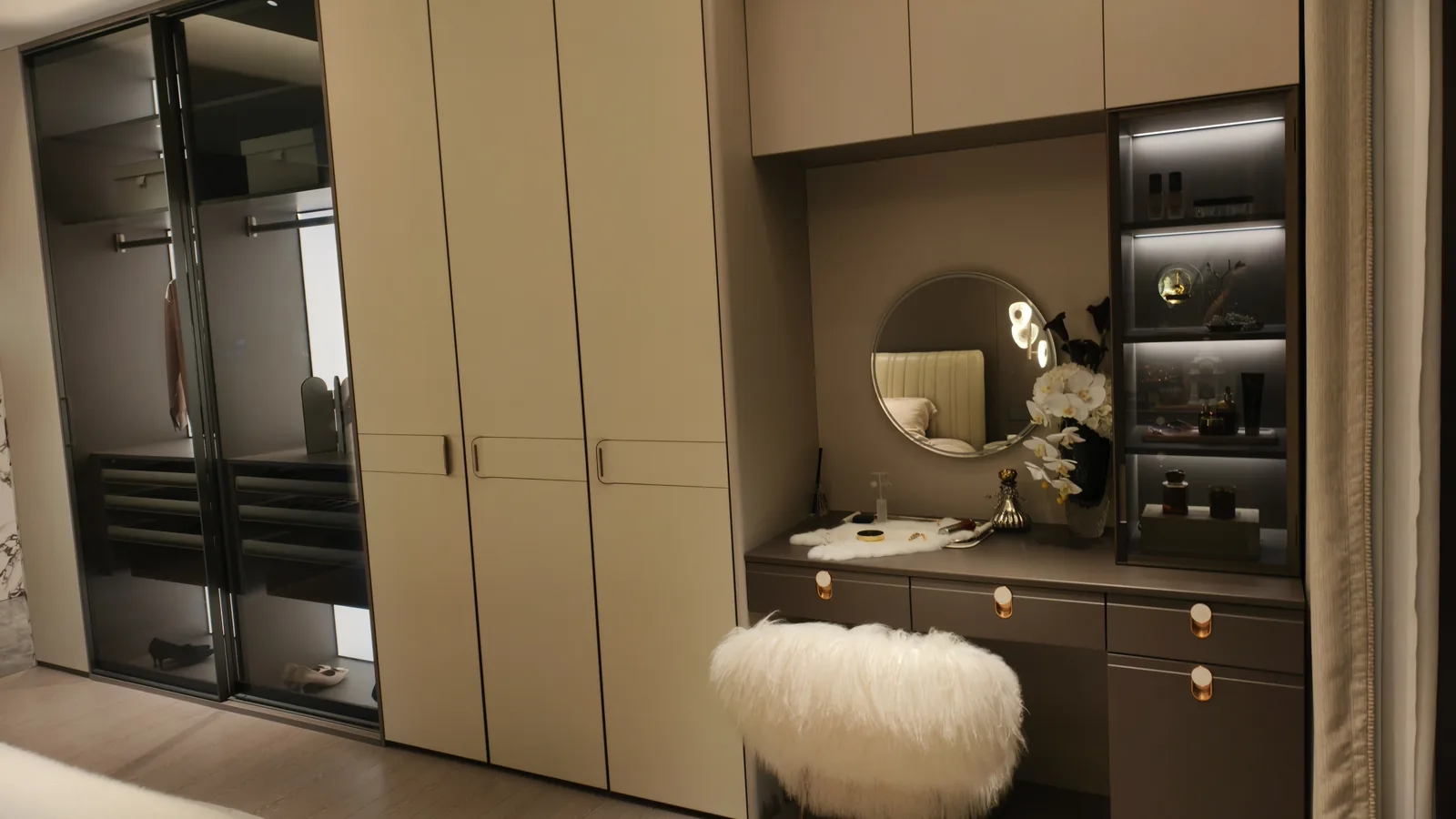 Bedroom suite with a full-height wardrobe, a dressing table with mirror and lit display shelves, and a frosted glass wardrobe
