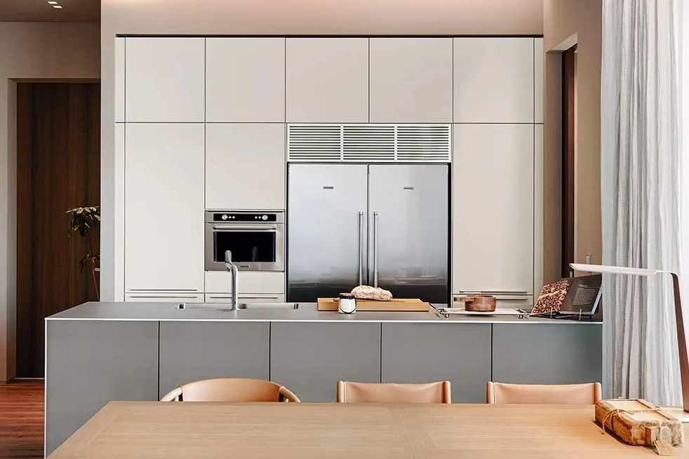 White kitchen program with oak island and full window wall, installed