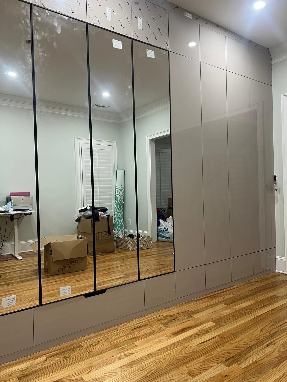 Unit kitchen with glass-front tall cabinet and wood floor