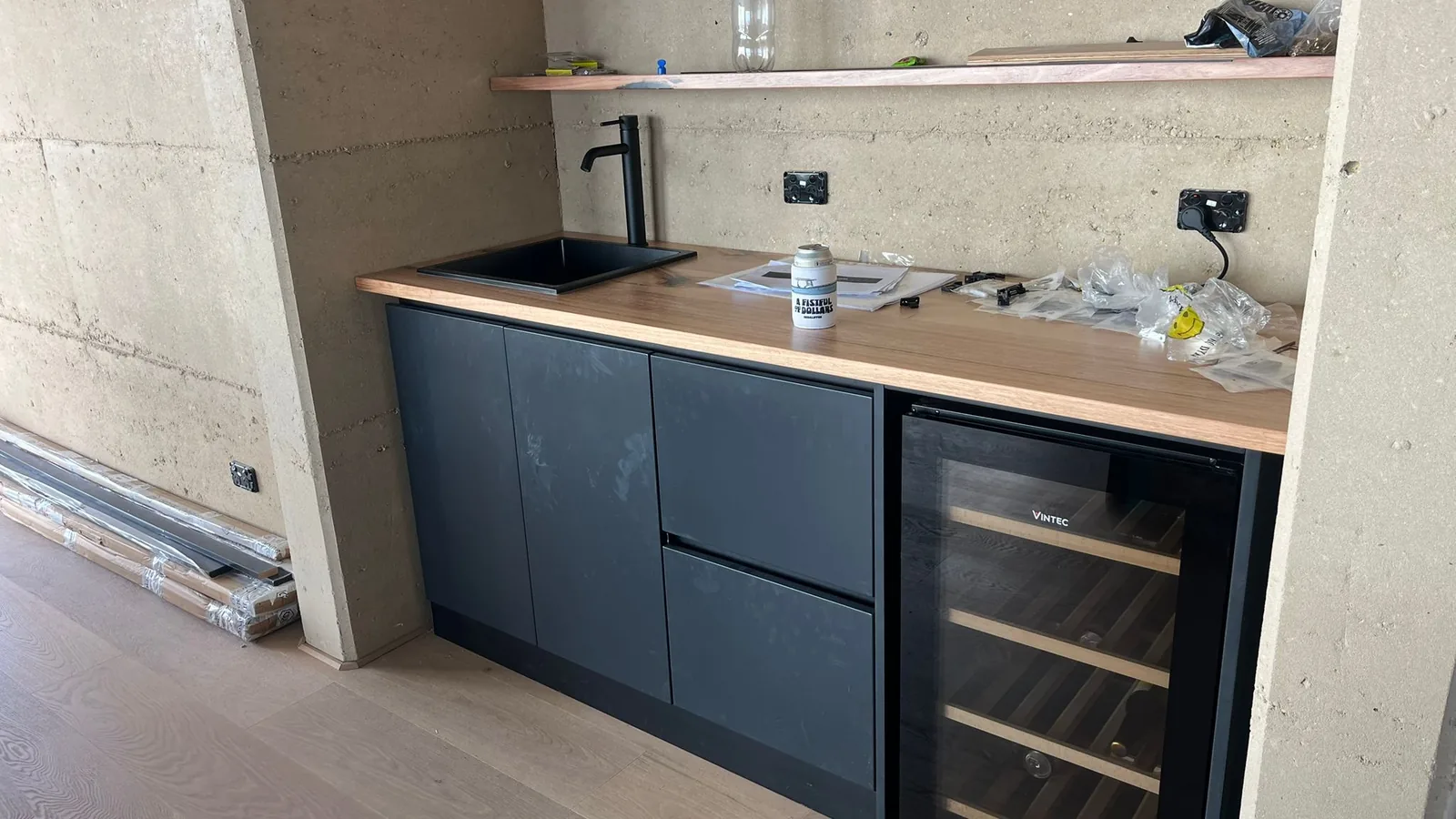 Dark lacquer kitchen with pale upper cabinets and a sea view, Australia