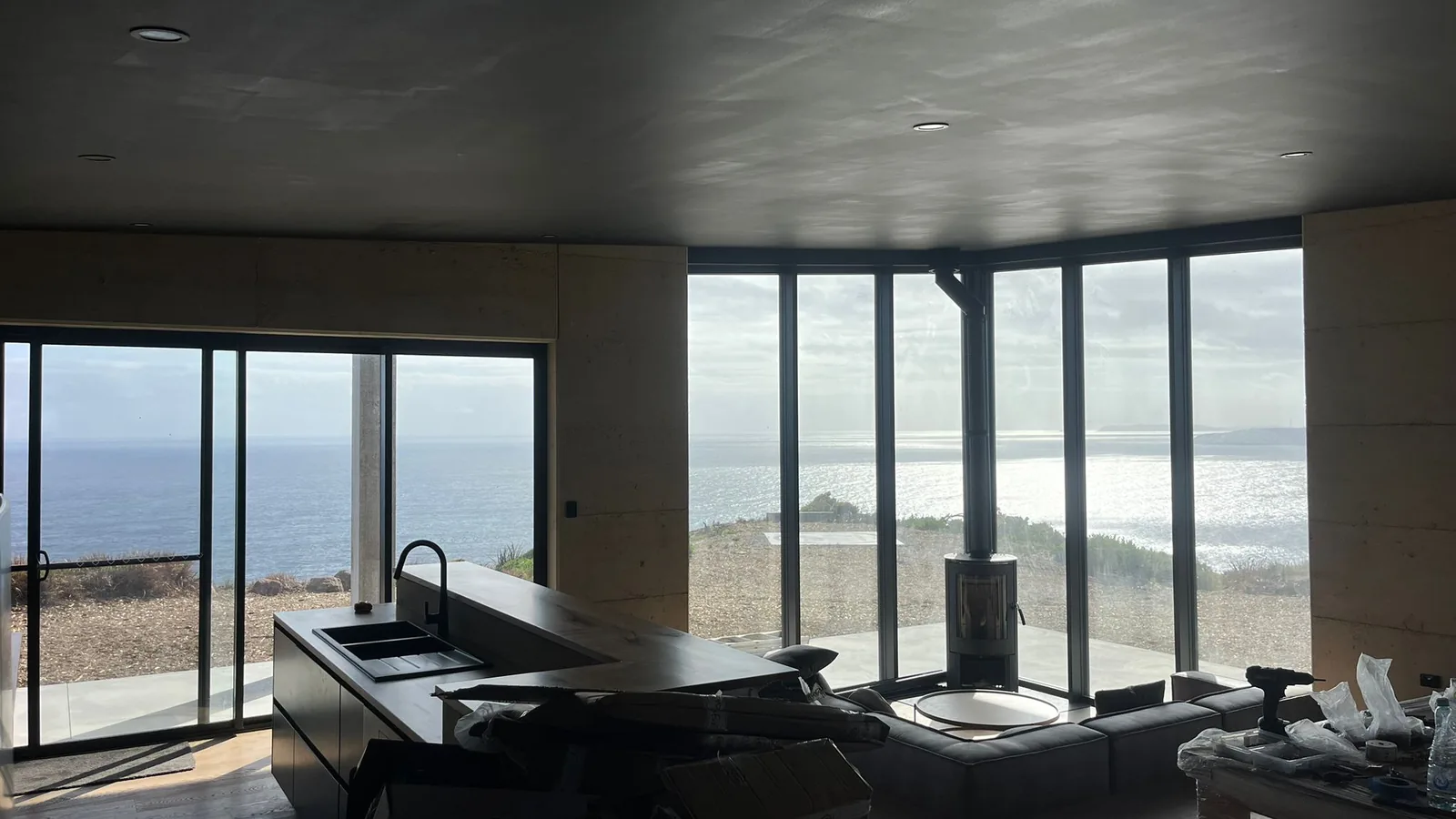 Living room with sea views and dark joinery
