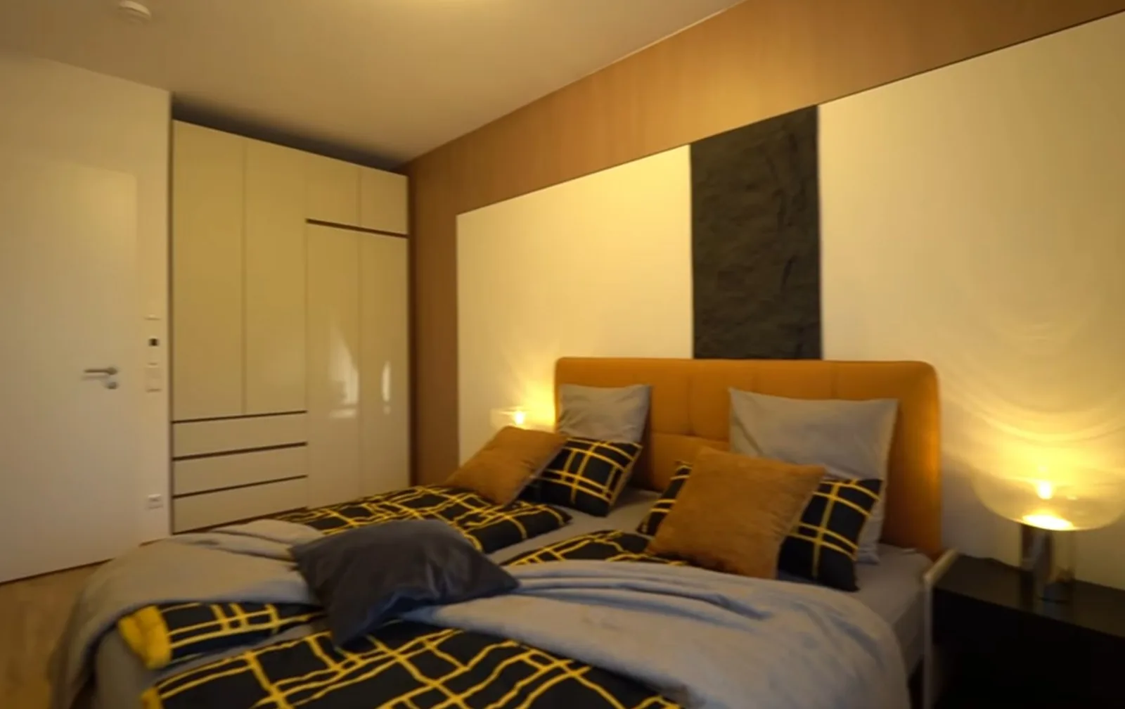 Walk-in closet with white fronts and wood shelves, UK