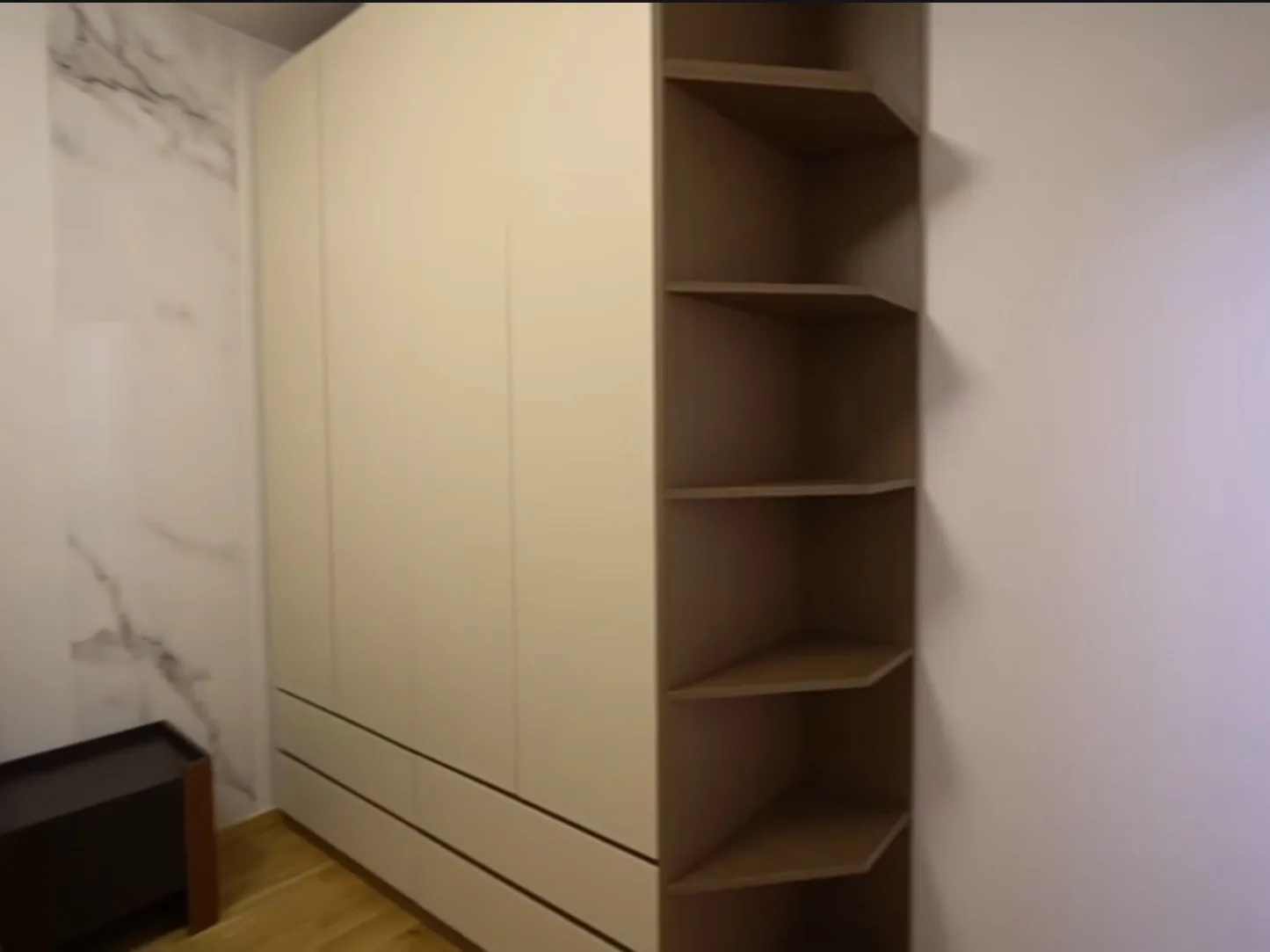 Dressing room with lit shelving to the ceiling, UK
