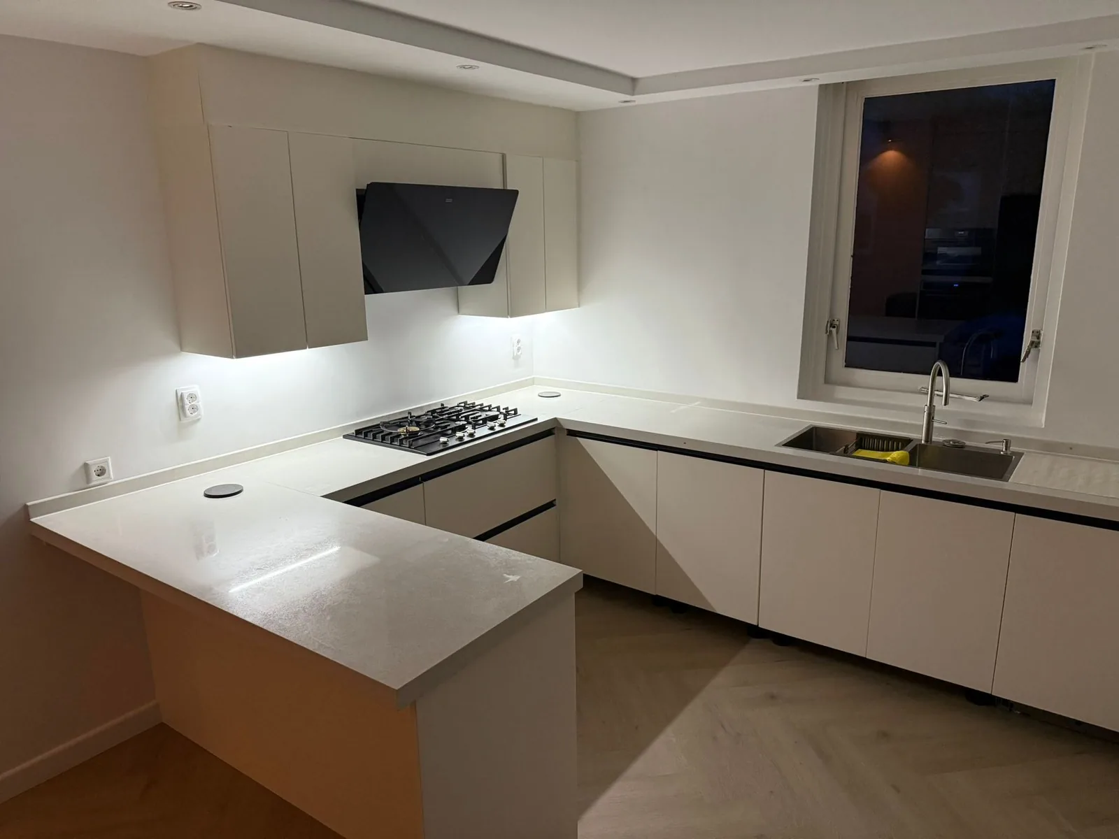 White kitchen island with black hood, UK