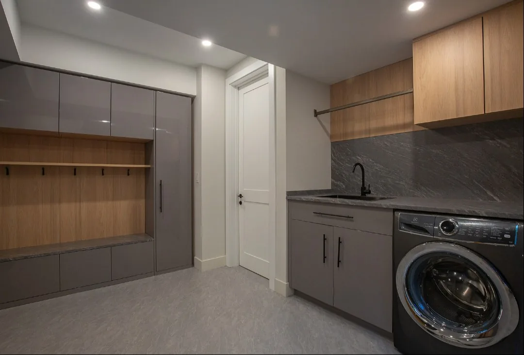 Laundry room with wood and white cabinets, UK