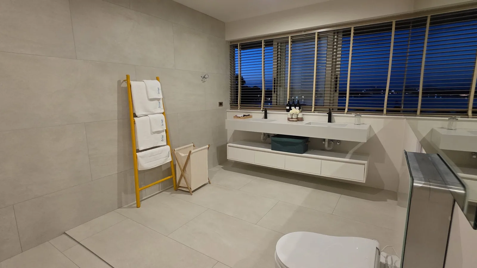 Vanity with stone top and timber carcass in a Thai villa bathroom