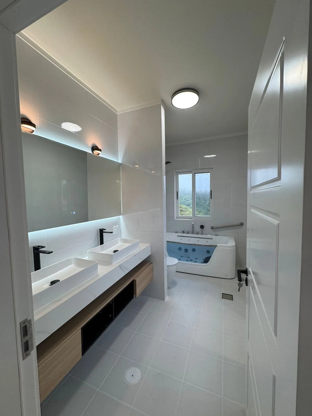 Master bath with freestanding tub, double vanity and mirror