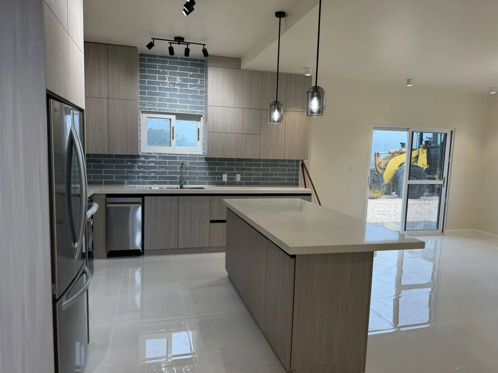 Kitchen from the dining side, oak fronts and stone worktop
