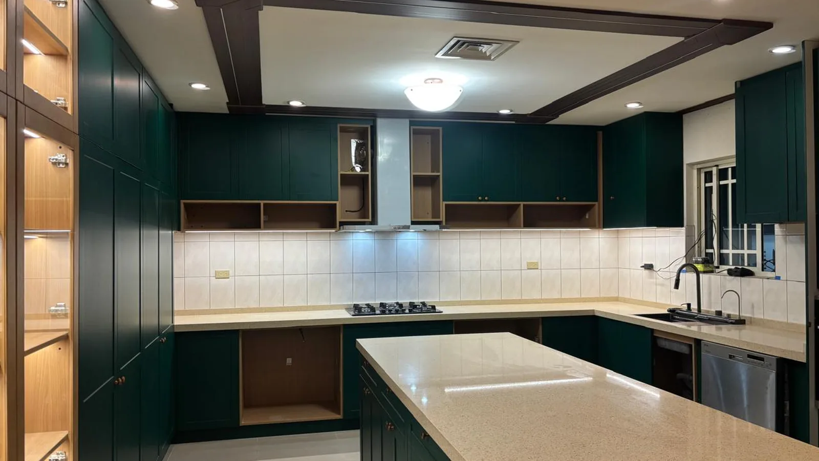 Deep green recessed-panel kitchen with quartz island, Guam