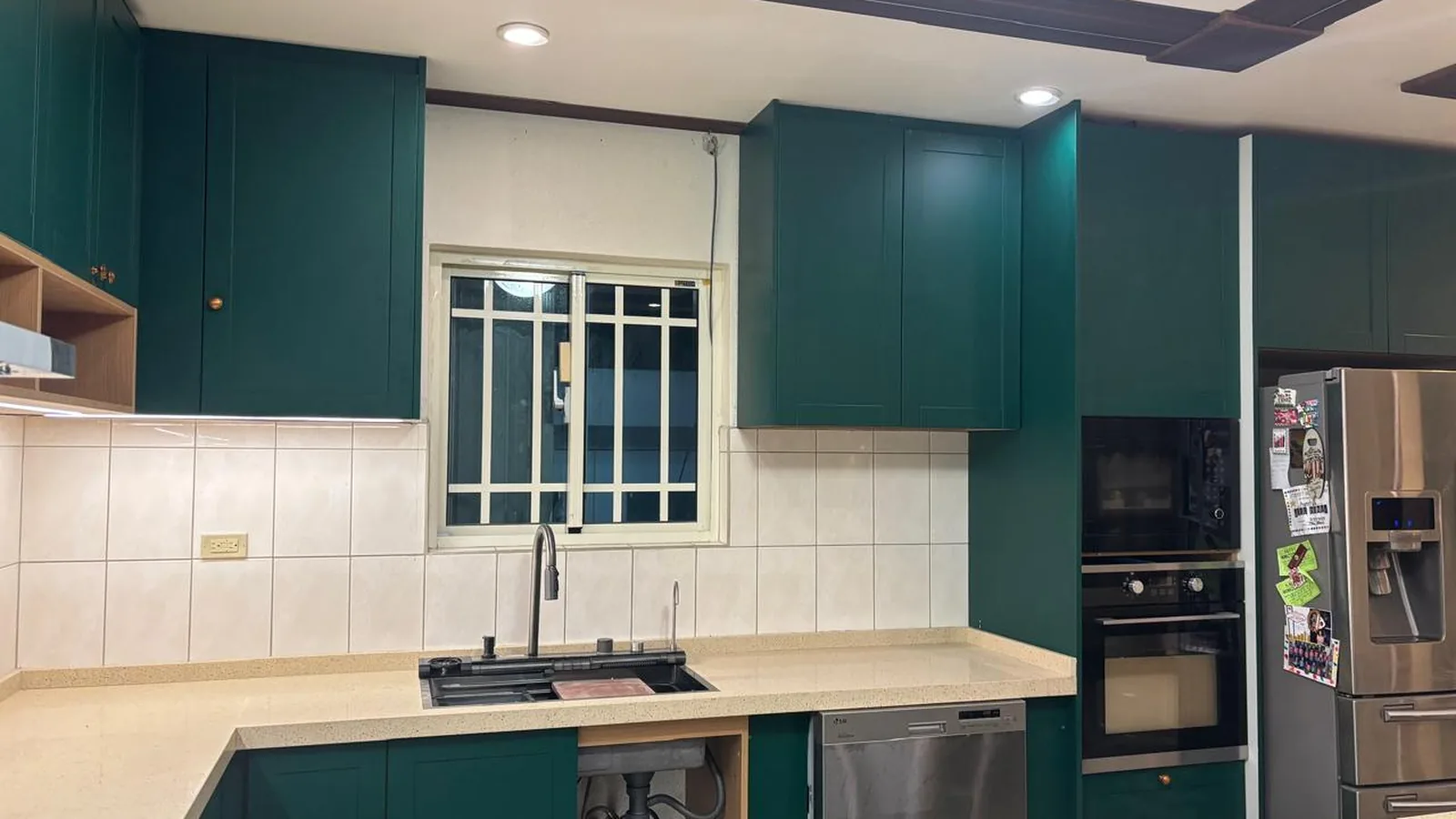 Kitchen sink run with window and green base units