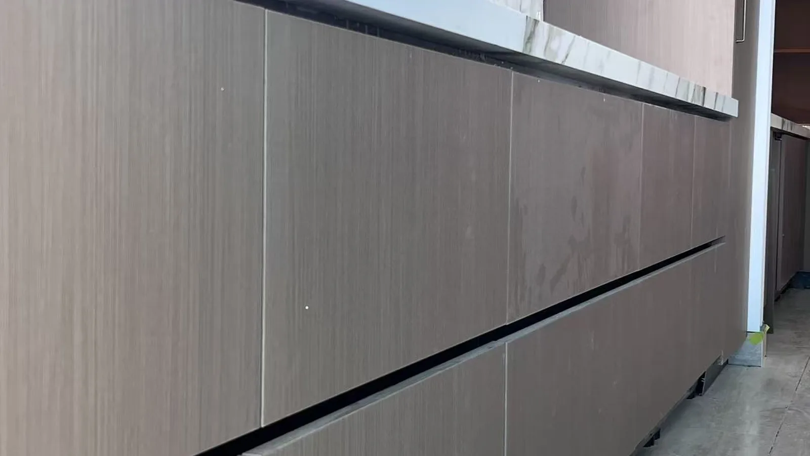 Long corridor with full-height cabinetry in an Australian builder project