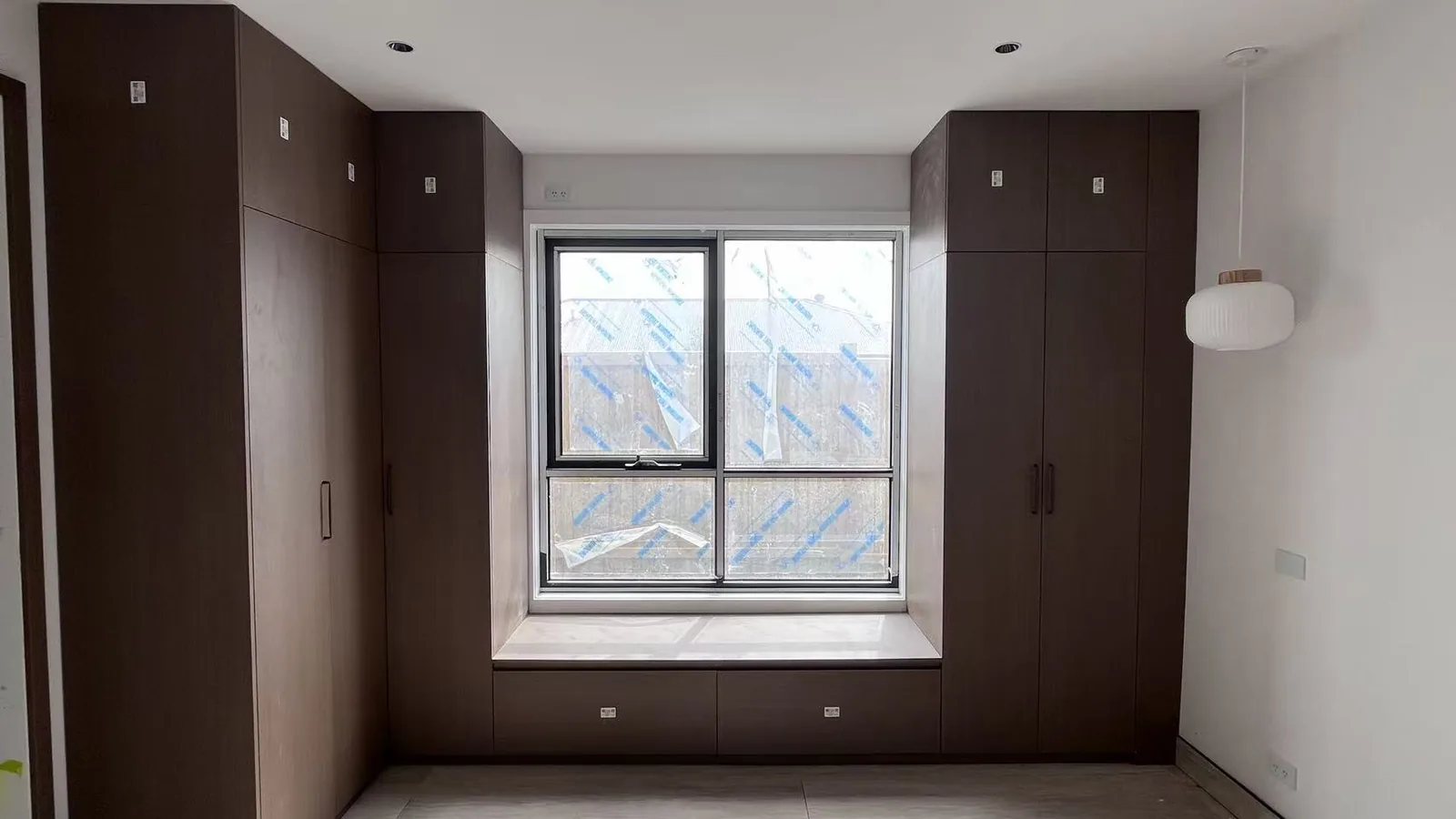 Bedroom wardrobe with timber fronts and full-height doors