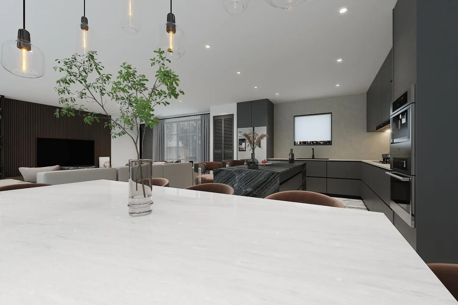 Dining area with stone table, pendants and the kitchen beyond