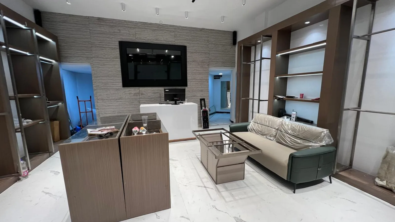 Fashion store counter and display units with timber fronts and marble floor