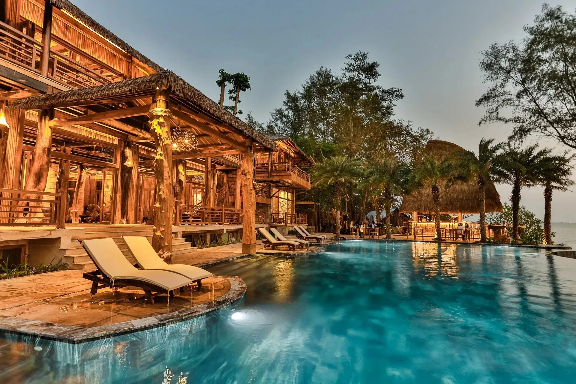 Wooden-style resort with pool at dusk, Nigeria