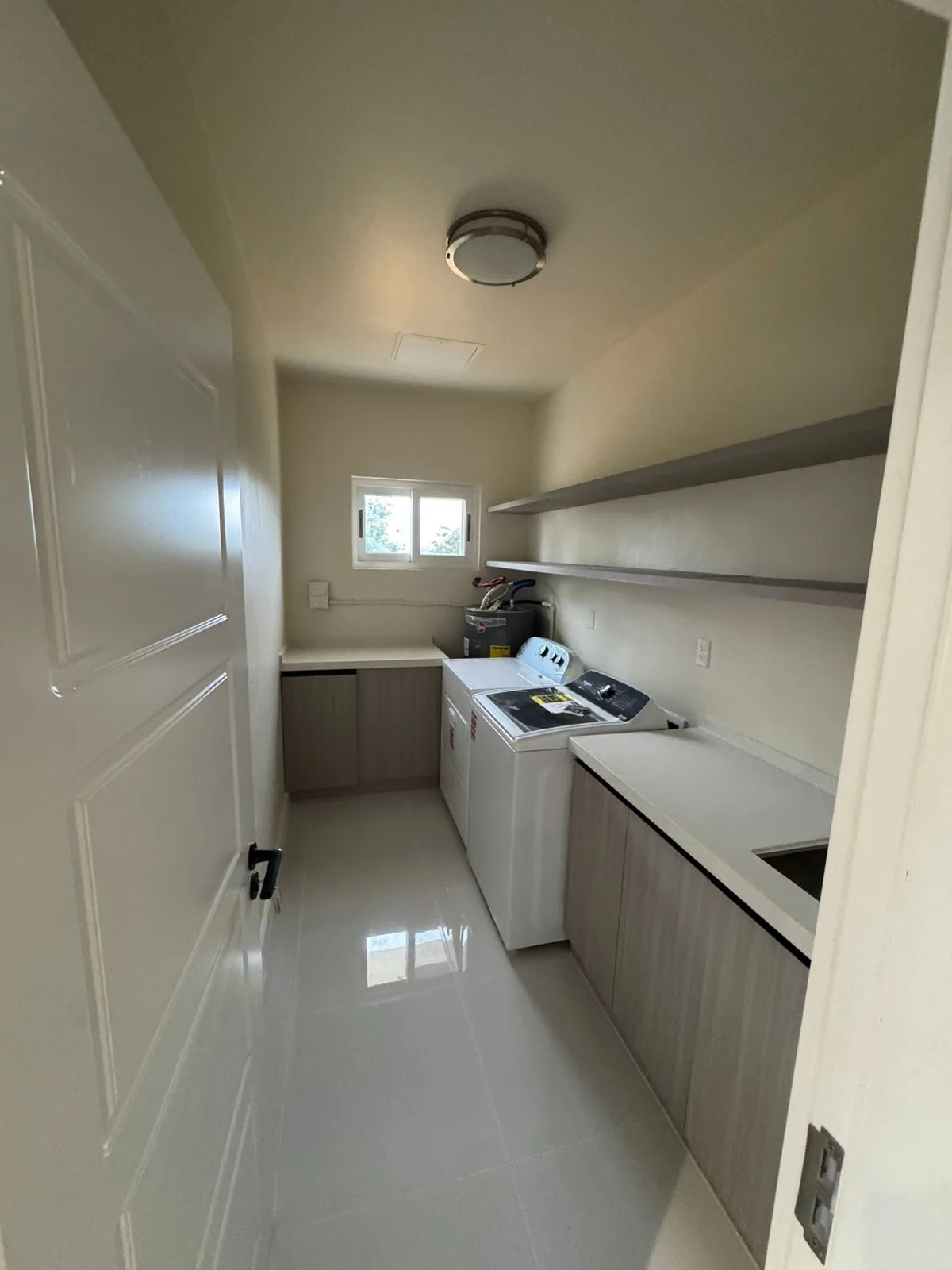Bath with long double vanity and tub beyond