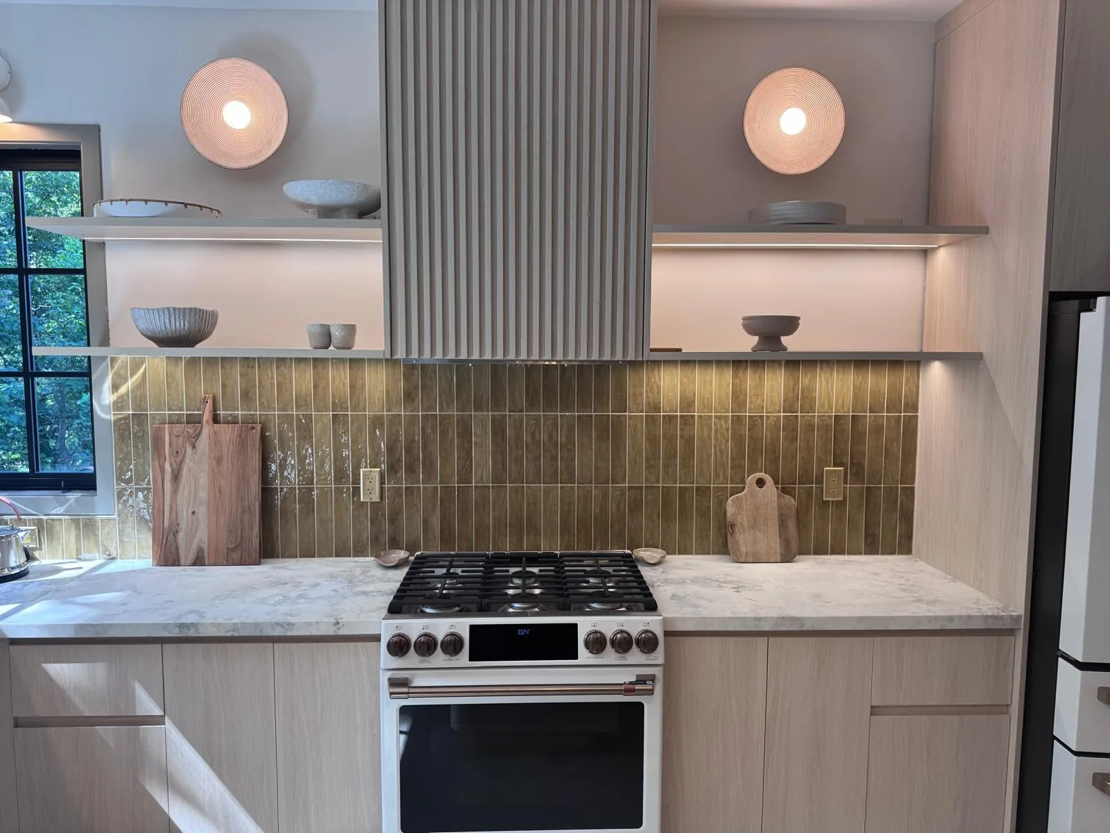 Completed kitchen with a marble worktop, tall run and pendant lighting in a Saudi villa