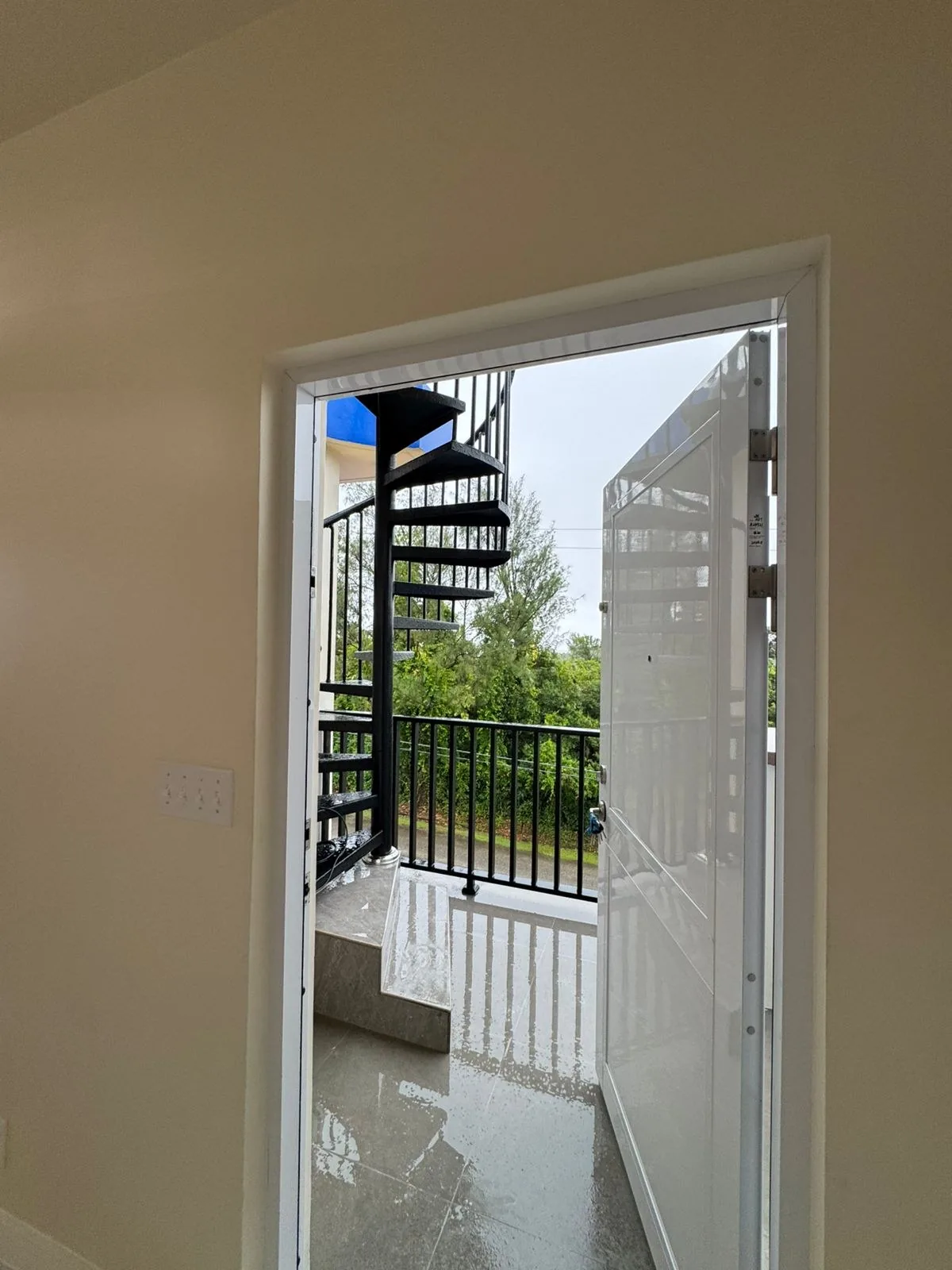 Balcony terrace with spiral staircase and glass railing