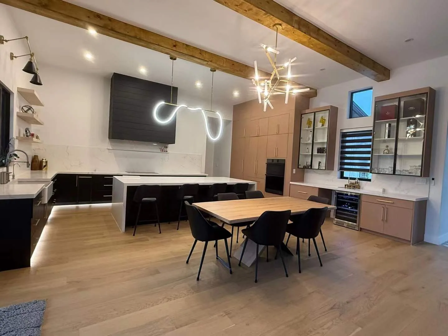 Dining room with wood ceiling beams and black chairs