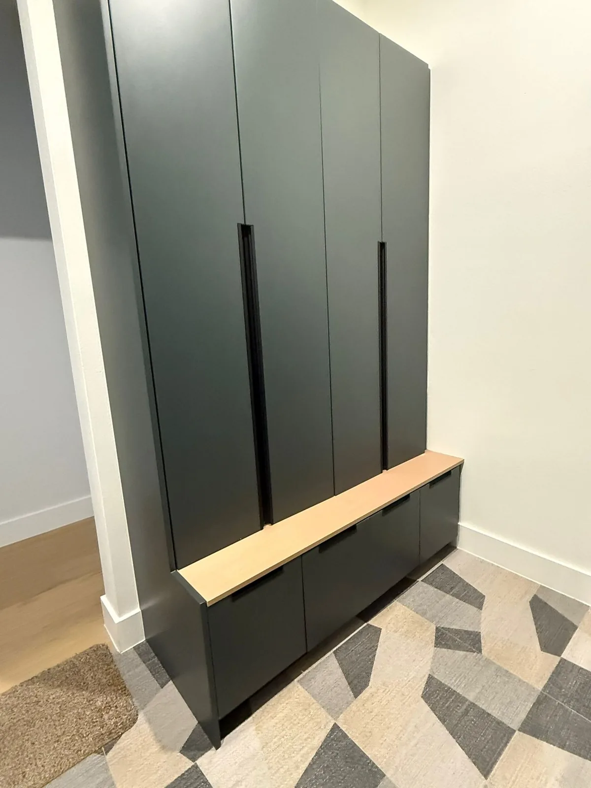 Entry with black cabinetry and checkered marble floor