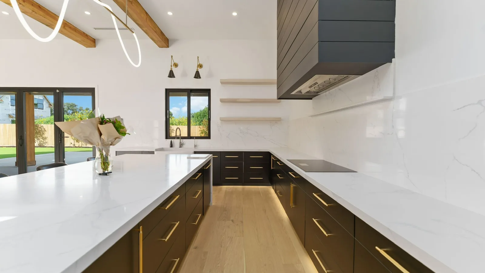 Stone-topped island in a white slab kitchen