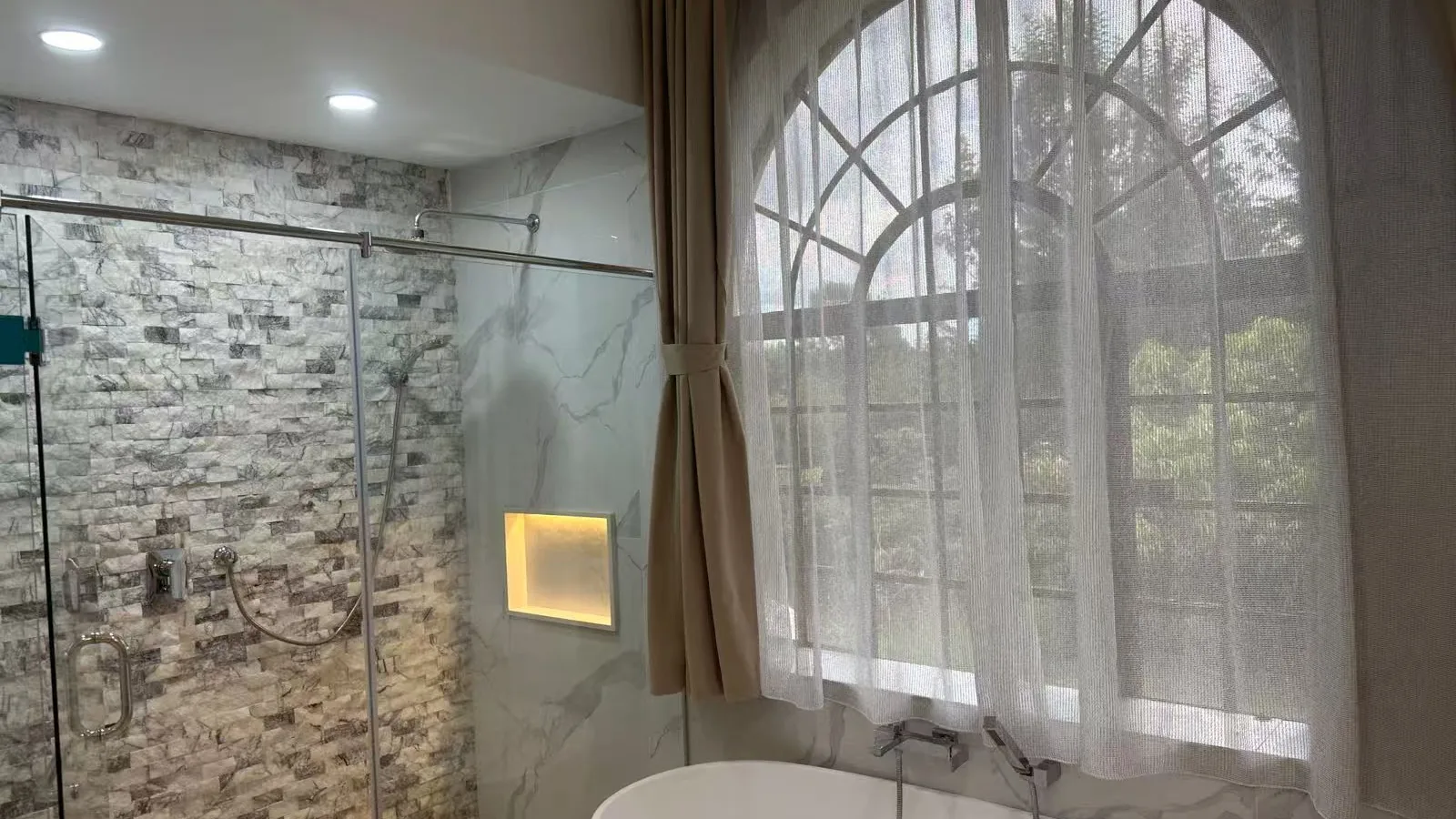 Washroom vanity with stone top and backlit mirror