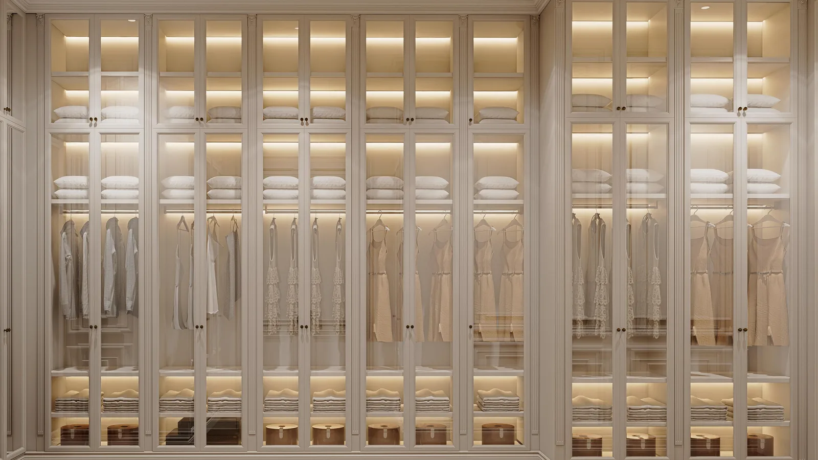 Walk-in closet with floor-to-ceiling glass-fronted wardrobes, bronze metal frames and warm LED lighting inside