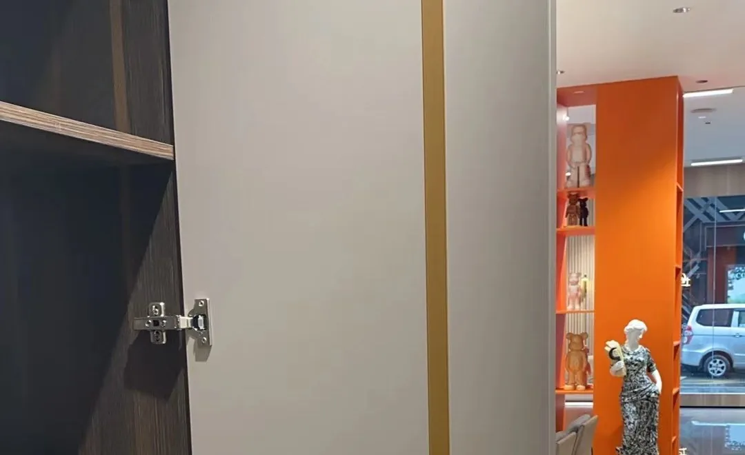 Soft-close hinges fitted on a walnut cabinet door