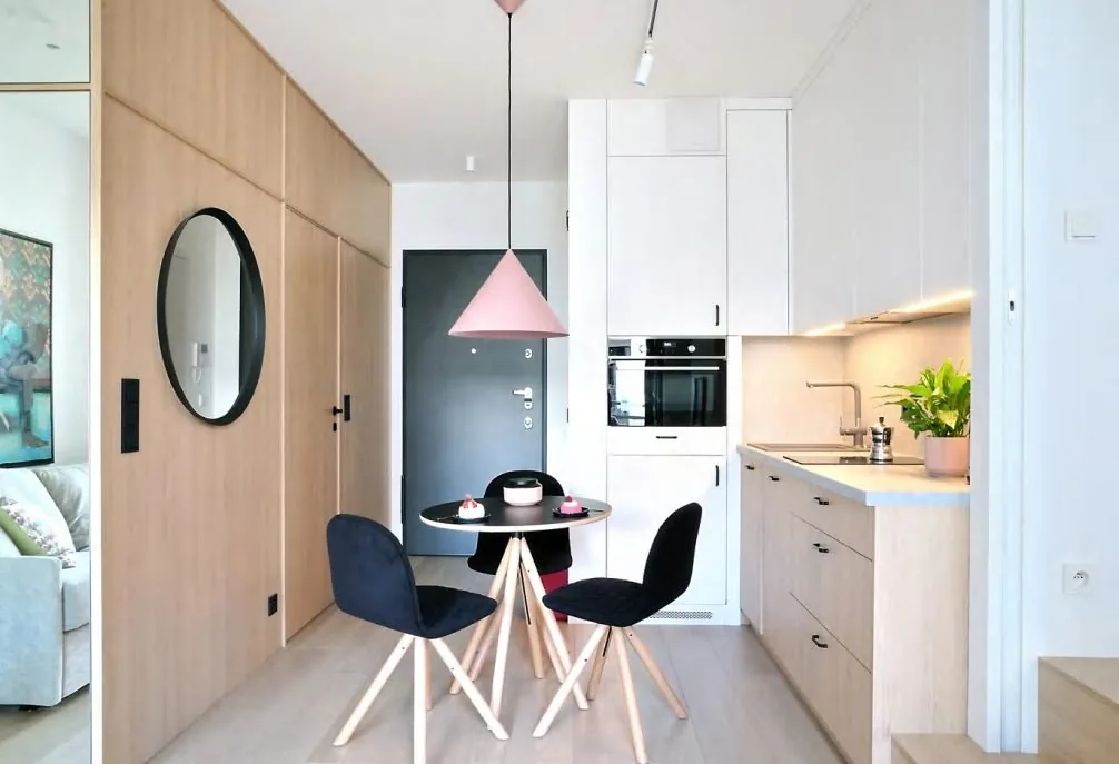 Narrow apartment kitchen with a compact run and a small dining nook