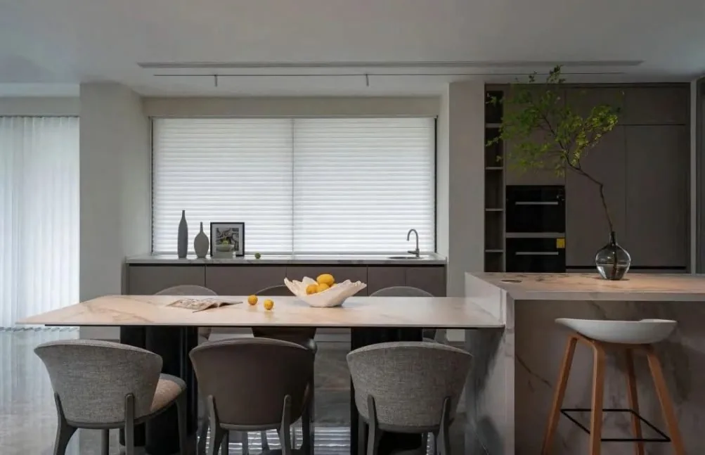 Dark kitchen run by the window with the tall appliance column