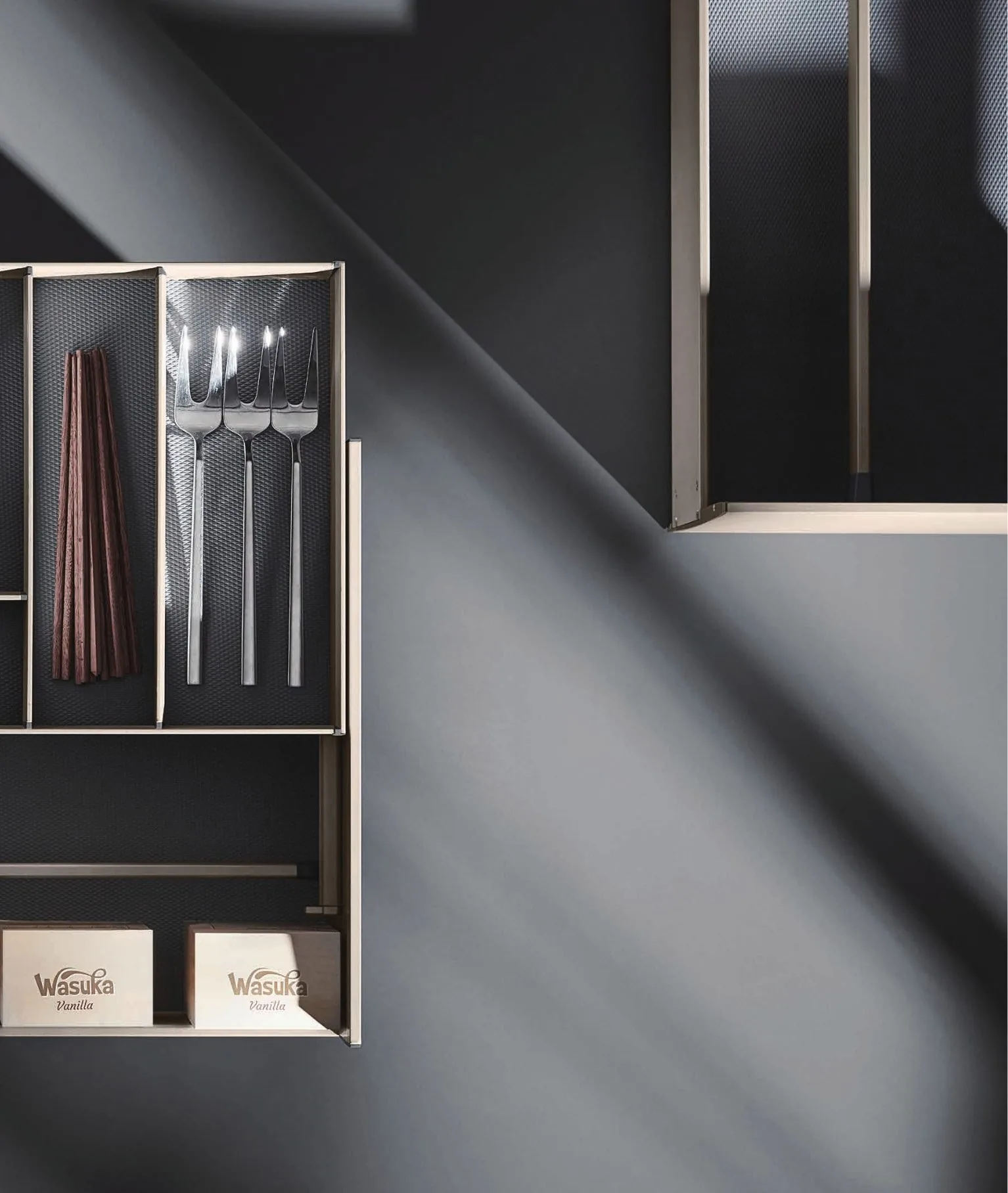 Open drawer with a tray-fitted cutlery interior