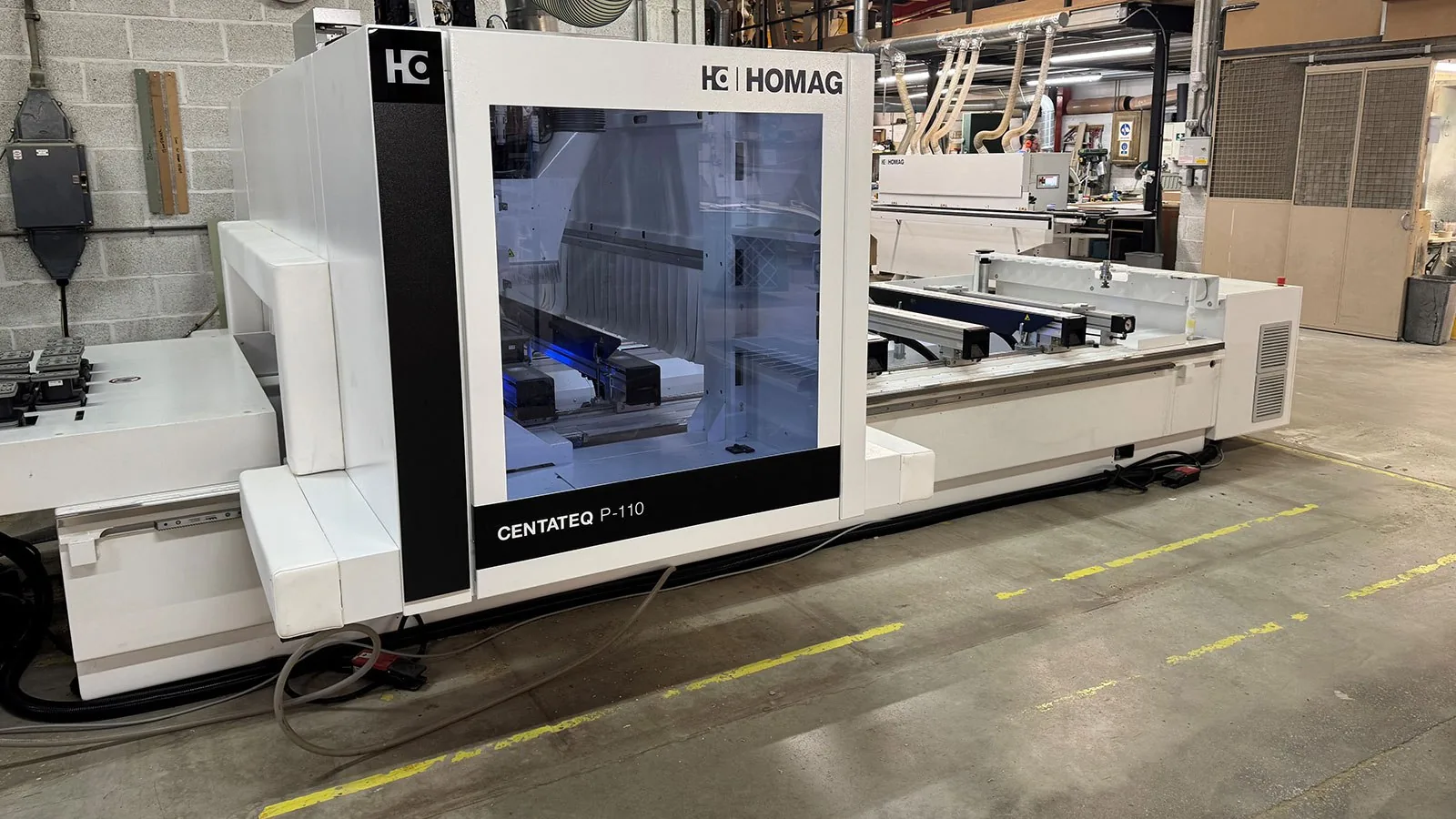 CNC machining center cutting cabinet boxes in the OEM line