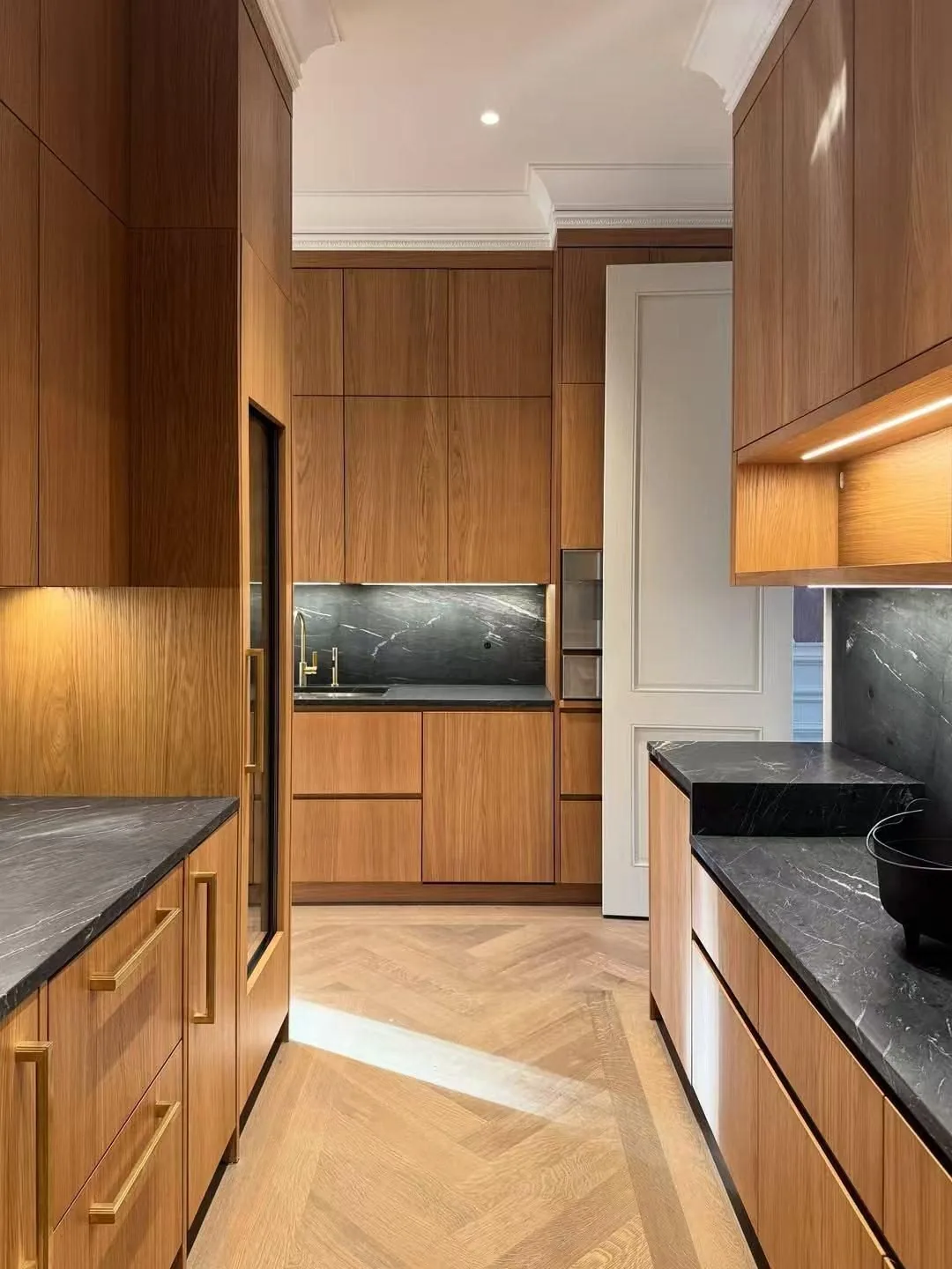 Warm wood kitchen with a full-height run, veneer faces