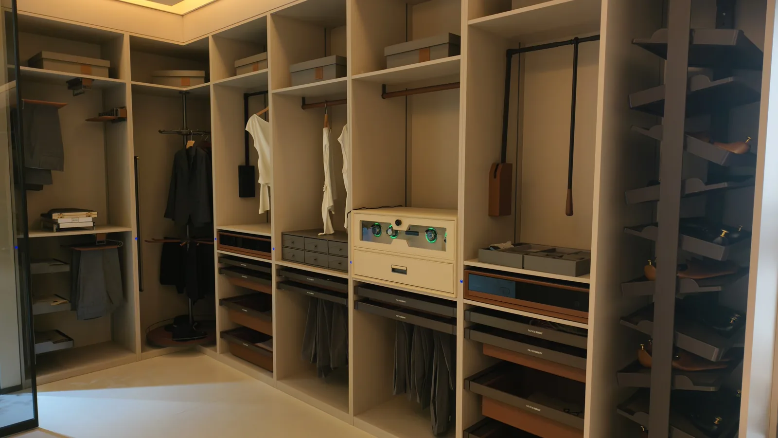 L-shaped walk-in wardrobe with hanging bays, shelves, drawer banks and pull-out trouser racks, photographed in a showroom