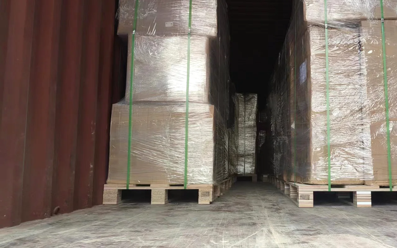 Flat-packed cabinet crates strapped and loaded in a shipping container