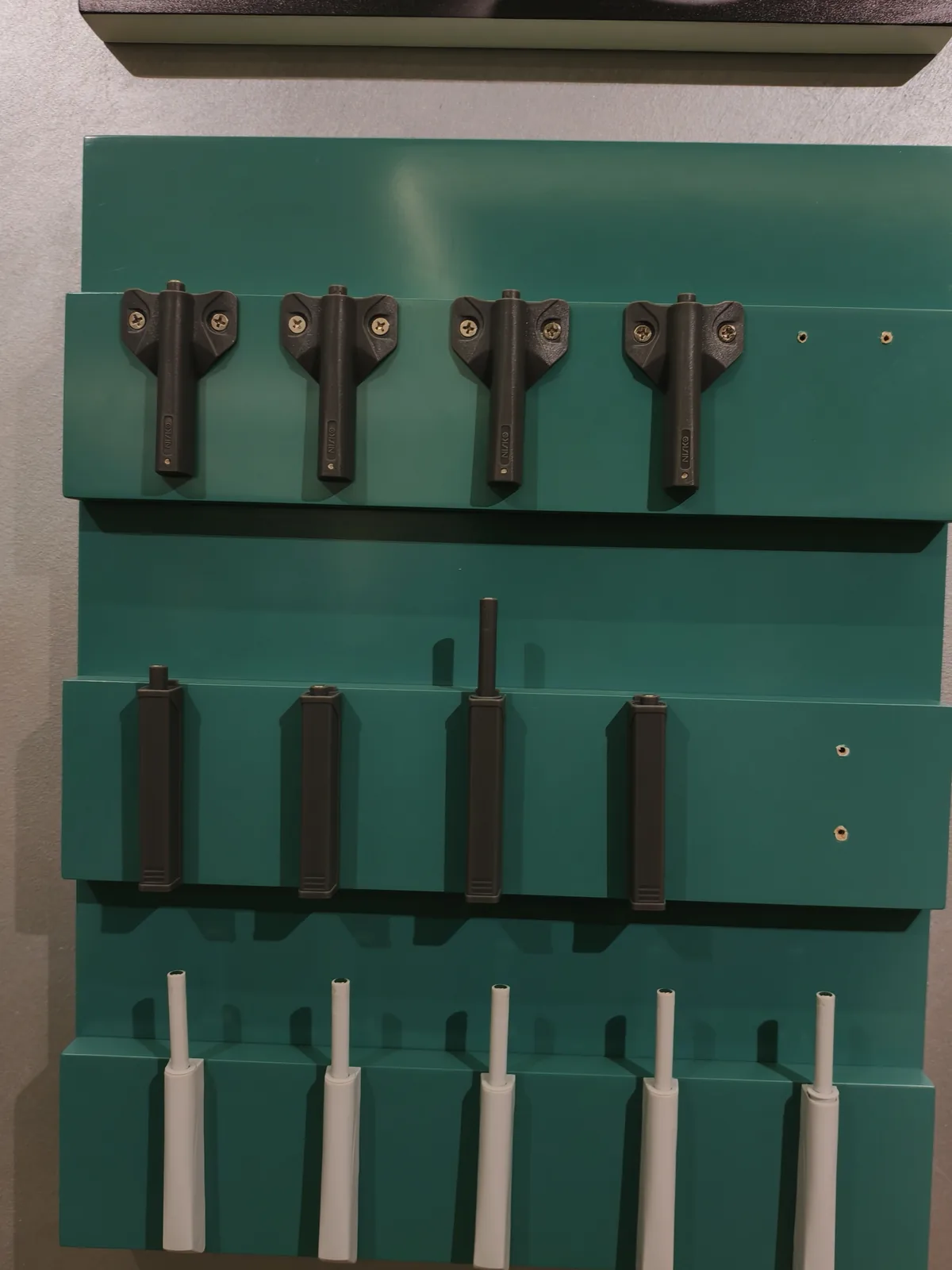 Display board of damping cylinders and push rods at a cabinet hardware showroom