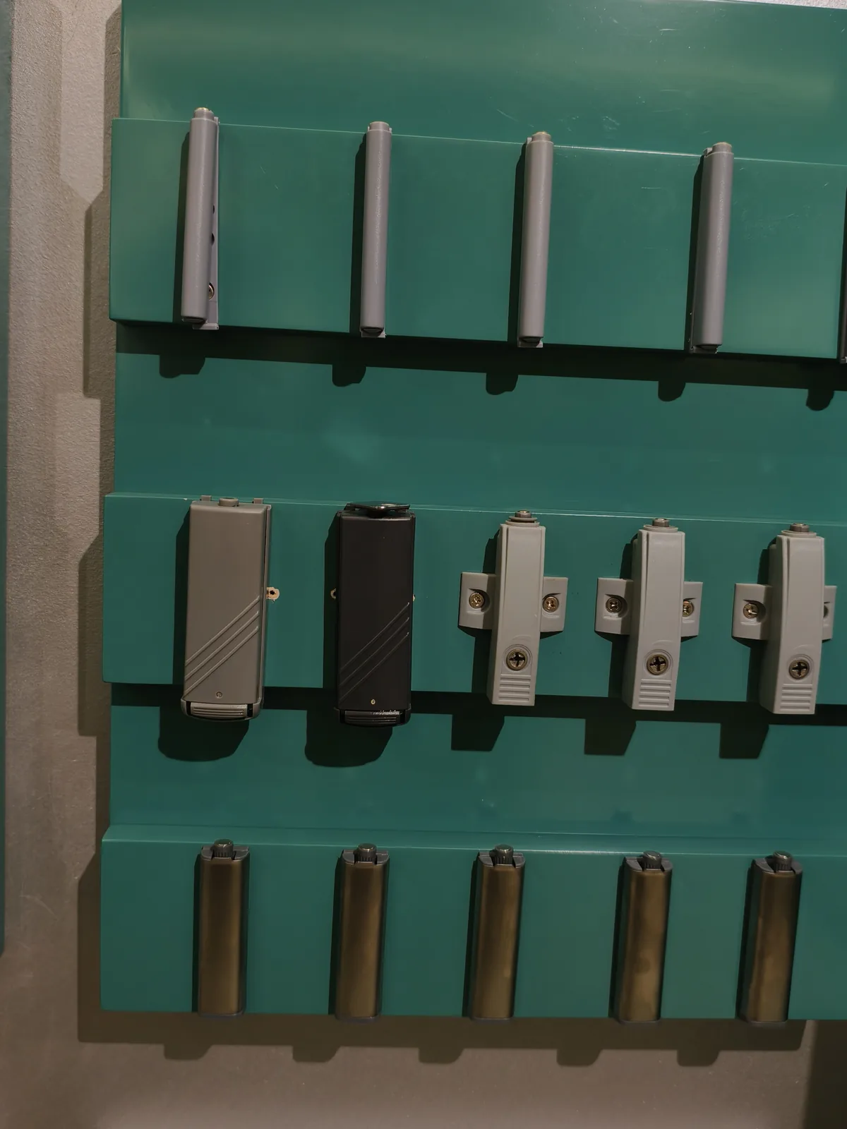 Push-to-open latches and hinge mounting plates on a display board